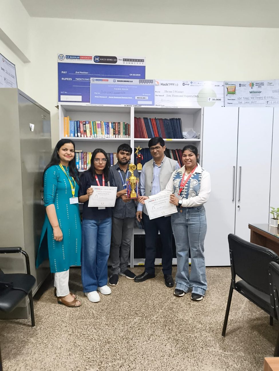 Team StarkMind with certificates and the INTELLITHON 2026 trophy